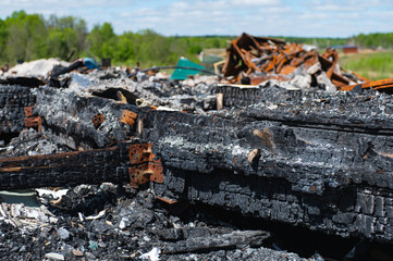 The conflagration. charred wood fragments, rusted and crumpled steel parts and all sorts of junk