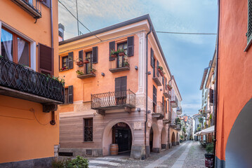 Fototapeta na wymiar Cuneo, Piedmont, Italy: Contrada Mondovì, ancient street in the historic center with decorated nineteenth-century buildings with arcades