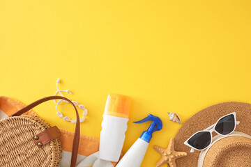 Seaside escape in the summer concept. Top view of cosmetic bottles, stylish beach bag, straw hat, eyewear, shell bracelet, towel, starfish on yellow background with empty space for advert or message