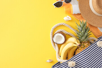 Tropical holiday concept for the summer. Top view photo of exotic fruits, beach bag, striped towel,...