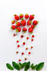 Cloud and rain from strawberries with mint on a white background. Vertical orientation, top view.