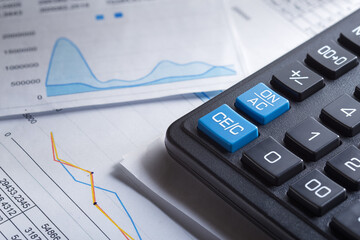 calculator and financial charts. Investment and capital accumulation concept
