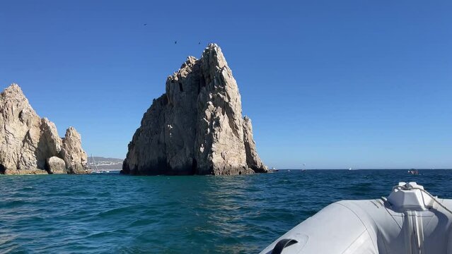 Zodiac cruising the waters towards the Cabo San Lucas arch in the Gulf of California where the Sea of Cortes meets the Pacific Ocean, in Baja California Sur, Mexico in search of whales. Boat concept.