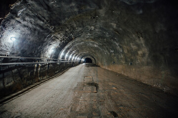 Dark large tunnel at old underground bunker