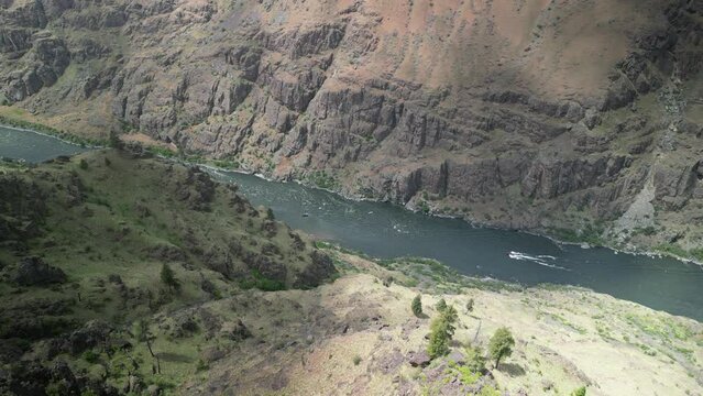 High aerial above boats on Snake River in Hells Canyon Recreation Area in Idaho in late spring time
