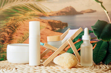 Fototapeta na wymiar Various generic white beauty product jars bottles against tropical vacation background. Skin and body care during holiday concept. Warm colors. 