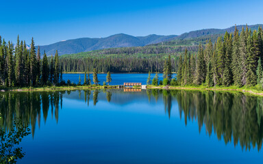 Tranquil morning reflecting on lake at William a Switzer Provincial Park, Alberta