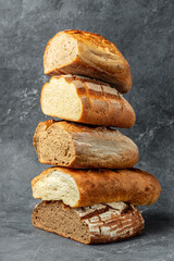 Bread slices and crumbs. Craft bakery. Homemade bread in the bakery. Bread background, vertical image. place for text