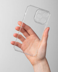 Hand holding mobile phone case, transparent smartphone protection