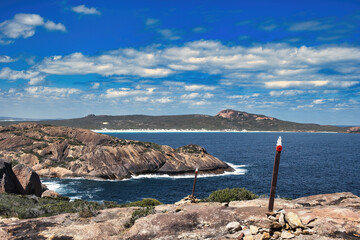 Trail markers of the Coastal Trail on the bare granite rocks of Cape Le Grand National Park, Western Australia. 