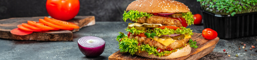 burger with double cutlet on a wooden board, Hamburger. Fast food concept. Long banner format