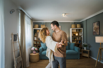 Happy couple adult caucasian man woman husband and wife dance at home - obrazy, fototapety, plakaty