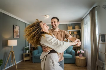 Fotobehang Happy couple adult caucasian man woman husband and wife dance at home © Miljan Živković
