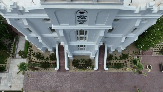 Aerial St George Utah LDS Temple front close climb 2. Southwestern desert. Pioneer temple in residential area built in 1877. First LDS temple in Utah. The Church of Jesus Christ of Latter-day Saints.