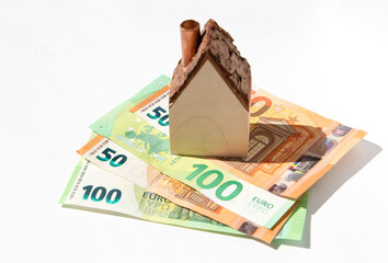 House standing on money. The concept of financial saving for buying a property