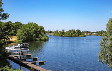 Obraz premium Beautiful dutch lake with lonely boat pier, green forest in summer - Leukermeer, Limburg, Netherlands