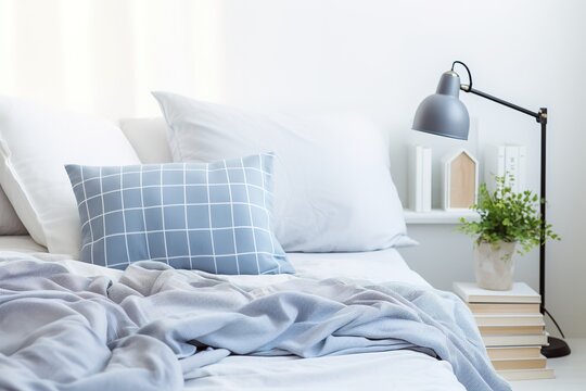 Modern bedroom, bed with blue blankets and blue pillows, close up