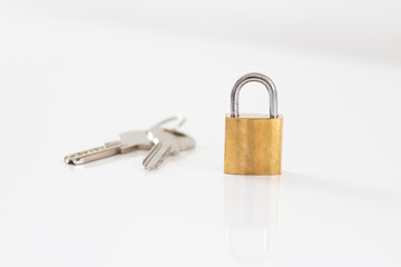 Gold locked padlock and keys on white background. Home security concept