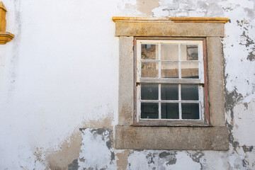 Square wooden frame and glass windows in a white vintage wall