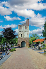 Fototapeta na wymiar Oud Bergen (Limburg), Netherlands - Juin 9. 2023: Beautiful dutch cemetery with medieval old church tower ruin in summer