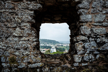 Window hole in the walls of a medieval castle in a rural town of Europe