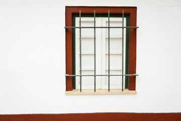 Fenced window frame in a wall