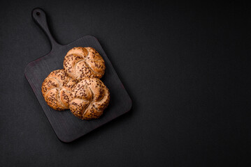 Delicious freshly baked crispy bun or kaiser roll with sesame seeds