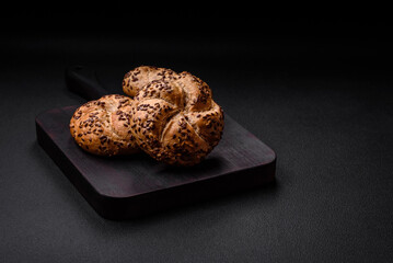 Delicious freshly baked crispy bun or kaiser roll with sesame seeds