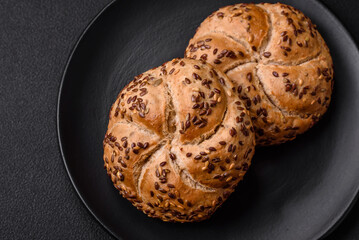 Delicious freshly baked crispy bun or kaiser roll with sesame seeds
