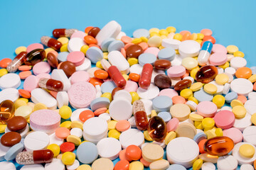 Many colorful different medicines and pills on top. The concept of medical treatment