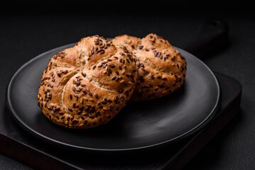 Delicious freshly baked crispy bun or kaiser roll with sesame seeds