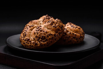 Delicious freshly baked crispy bun or kaiser roll with sesame seeds