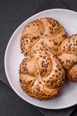 Delicious freshly baked crispy bun or kaiser roll with sesame seeds