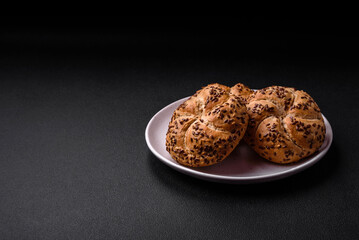 Delicious freshly baked crispy bun or kaiser roll with sesame seeds