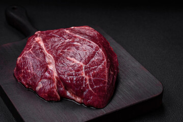 Fresh raw beef steak with salt, spices and herbs