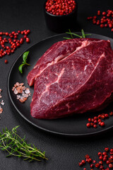 Fresh raw beef steak with salt, spices and herbs