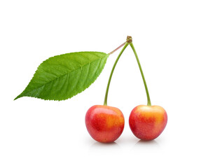 Two red-yellow sweet cherries with green leaf isolated on white background	