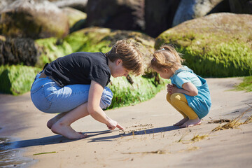 Two sisters are playing on the beach in Denmark