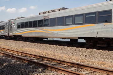 Fototapeta premium Domestic train pass the rail way when day time with blue sky.