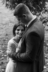 the young bride gently clings to the groom's chest. wedding day in autumn time.amazingly beautiful couple of newlyweds.