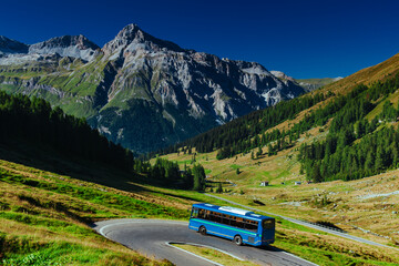 Passenger bus riding at Swiss Alps mountains in summer © chaossart