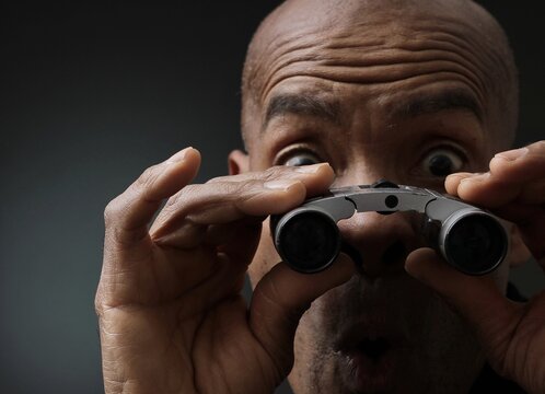 man looking through binoculars look ahead for the future with people stock photo