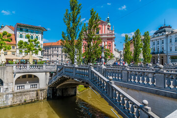 A view across the Triple Bridge over the River Ljubljanica towards the castle in Ljubljana, Slovenia in summertime