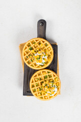 Appetizer Round Corn waffles. On a wooden board. White background. Top view	