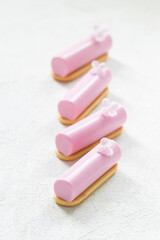 Pink tea matcha cream dessert cake bar, decorated with a small flower. On cookies. Creamy dessert with the addition of pink pitaya powder. White background