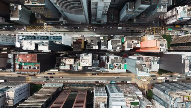 Hyperlapse timelapse of car traffic on road junction intersection in Hong Kong city downtown. Drone aerial top view fly sideway. Asian people lifestyle, Asia city life or public transportation concept