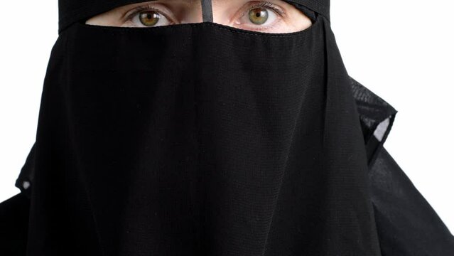 Muslim female in black niqab. Closeup