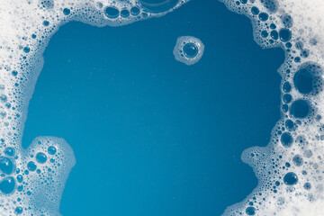 Detergent foam bubble on water. Blue background, Soap sud - obrazy, fototapety, plakaty