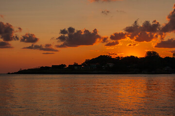 Dawn over the Black sea in Bulgaria, place Kiten, Burgas Province. The sun rises on the horizon and is reflected in the water. Panorama.