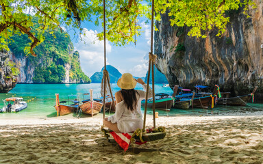 Traveler woman relaxing on swing joy nature scenic landscape Lao Lading beach island Krabi, Famous...
